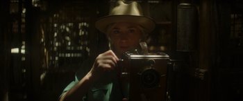 Movie still from “Jungle Cruise” (2021), directed by Jaume Collet-Serra – A woman in a hat holding a camera; Close Up shot, Low angle