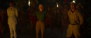 Movie still from “Jungle Cruise” (2021), directed by Jaume Collet-Serra – A woman standing in front of a group of statues; Wide shot, Over the shoulder angle