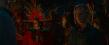 Movie still from “Jungle Cruise” (2021), directed by Jaume Collet-Serra – A woman standing in front of a group of people wearing masks; Close Up shot, Over the shoulder angle