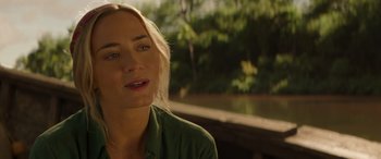 Movie still from “Jungle Cruise” (2021), directed by Jaume Collet-Serra – A person wearing a green shirt near a body of water; Close Up shot, Over the shoulder angle