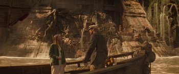Movie still from “Jungle Cruise” (2021), directed by Jaume Collet-Serra – A man and a woman are standing in front of a rock wall; Wide shot, Over the shoulder angle