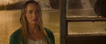 Movie still from “Jungle Cruise” (2021), directed by Jaume Collet-Serra – A woman with long blonde hair standing in a room; Close Up shot, Over the shoulder angle