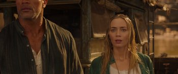 Movie still from “Jungle Cruise” (2021), directed by Jaume Collet-Serra – A woman standing next to a man in front of a building; Close Up shot, Over the shoulder angle