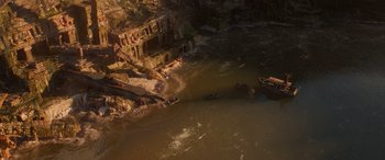Movie still from “Jungle Cruise” (2021), directed by Jaume Collet-Serra – A body of water that has a lot of rocks in it; Extreme Wide shot, Overhead angle