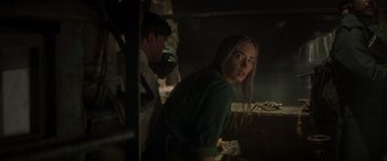 Movie still from “Jungle Cruise” (2021), directed by Jaume Collet-Serra – A woman standing next to a man in a dark room; Medium shot, Over the shoulder angle