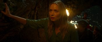 Movie still from “Jungle Cruise” (2021), directed by Jaume Collet-Serra – A beautiful blonde woman in a green shirt looking at the camera; Close Up shot, Over the shoulder angle
