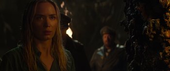 Movie still from “Jungle Cruise” (2021), directed by Jaume Collet-Serra – A woman standing next to two men in a dark room; Close Up shot, Over the shoulder angle