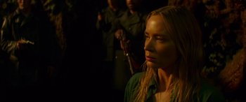 Movie still from “Jungle Cruise” (2021), directed by Jaume Collet-Serra – A woman in a green shirt is in the dark; Close Up shot, Over the shoulder angle