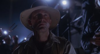 Movie still from “Jurassic Park” (1993), directed by Steven Spielberg – A person wearing a hat; Close Up shot, Low angle