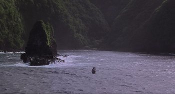 Movie still from “Jurassic Park” (1993), directed by Steven Spielberg – A person in a boat in the middle of a body of water; Extreme Wide shot, High angle