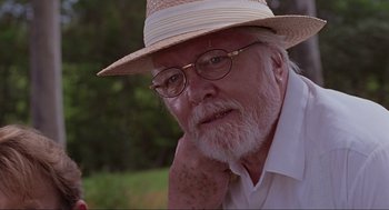 Movie still from “Jurassic Park” (1993), directed by Steven Spielberg – An older man wearing a straw hat and glasses; Close Up shot, Low angle