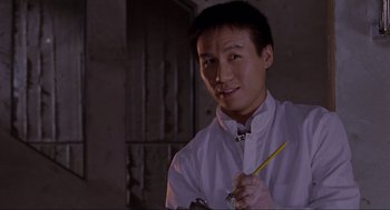 Movie still from “Jurassic Park” (1993), directed by Steven Spielberg – A man holding a pencil in his right hand; Close Up shot, Low angle