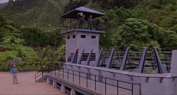 Movie still from “Jurassic Park” (1993), directed by Steven Spielberg – A group of men standing on top of a building; Extreme Wide shot, High angle