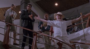 Movie still from “Jurassic Park” (1993), directed by Steven Spielberg – A group of people standing on top of a wooden railing; Medium shot, Low angle