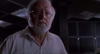 Movie still from “Jurassic Park” (1993), directed by Steven Spielberg – An older man with a beard and glasses; Close Up shot, Low angle