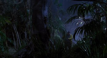 Movie still from “Jurassic Park” (1993), directed by Steven Spielberg – Two people in the woods at night; Extreme Wide shot, High angle