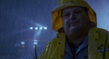 Movie still from “Jurassic Park” (1993), directed by Steven Spielberg – A man wearing a yellow rain coat and a yellow rain hat; Close Up shot, Low angle