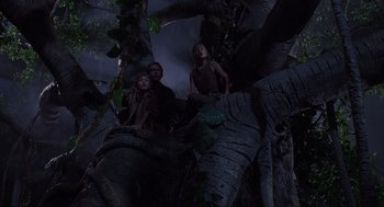 Movie still from “Jurassic Park” (1993), directed by Steven Spielberg – A man and two children sitting in a tree; Wide shot, Low angle