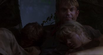Movie still from “Jurassic Park” (1993), directed by Steven Spielberg – A man and two children sleeping next to each other; Close Up shot, Low angle