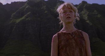 Movie still from “Jurassic Park” (1993), directed by Steven Spielberg – A young girl in a brown dress looking up at the sky; Medium shot, Low angle