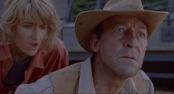 Movie still from “Jurassic Park” (1993), directed by Steven Spielberg – A man and a woman wearing hats and looking into the distance; Close Up shot, Low angle