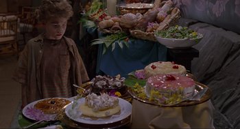 Movie still from “Jurassic Park” (1993), directed by Steven Spielberg – Many different cakes on the table; Medium shot, High angle