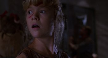 Movie still from “Jurassic Park” (1993), directed by Steven Spielberg – A young girl is looking into the distance; Close Up shot, Low angle