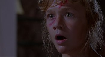 Movie still from “Jurassic Park” (1993), directed by Steven Spielberg – A person with a face covered in blood; Close Up shot, Low angle
