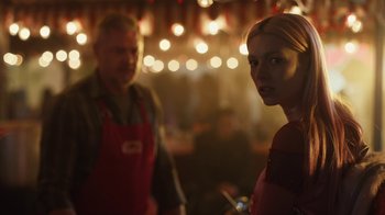 Movie still from “Euphoria” (2019), created by Sam Levinson – A man and a woman standing next to each other in front of lights; Medium shot, Over the shoulder angle