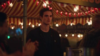 Movie still from “Euphoria” (2019), created by Sam Levinson – A man standing in front of a tent at night; Medium shot, Over the shoulder angle