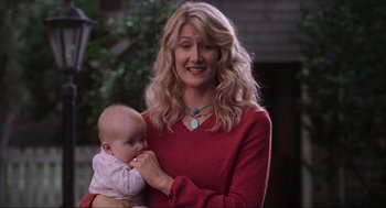 Movie still from “Jurassic Park III” (2001), directed by Joe Johnston – A woman in a red sweater holding a baby; Close Up shot, Low angle