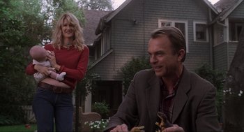 Movie still from “Jurassic Park III” (2001), directed by Joe Johnston – A man and a woman sitting at an outdoor table; Medium shot, Low angle