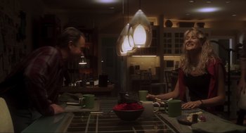 Movie still from “Jurassic Park III” (2001), directed by Joe Johnston – A man and a woman sitting at a dining table; Medium shot, Over the shoulder angle