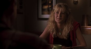Movie still from “Jurassic Park III” (2001), directed by Joe Johnston – A woman sitting at a table with a cup of coffee; Close Up shot, Over the shoulder angle