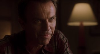 Movie still from “Jurassic Park III” (2001), directed by Joe Johnston – A person wearing a plaid shirt; Close Up shot, Over the shoulder angle