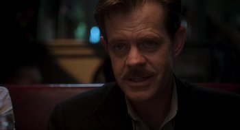 Movie still from “Jurassic Park III” (2001), directed by Joe Johnston – A person wearing a suit and tie; Close Up shot, Over the shoulder angle