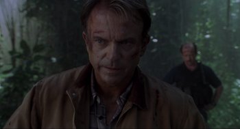 Movie still from “Jurassic Park III” (2001), directed by Joe Johnston – A person wearing a shirt and jacket; Close Up shot, Over the shoulder angle