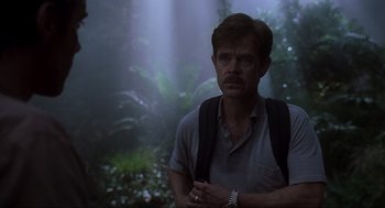 Movie still from “Jurassic Park III” (2001), directed by Joe Johnston – A man with a backpack standing in the woods; Medium shot, Over the shoulder angle