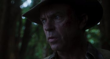 Movie still from “Jurassic Park III” (2001), directed by Joe Johnston – A person wearing a hat and looking to his left; Close Up shot, Over the shoulder angle