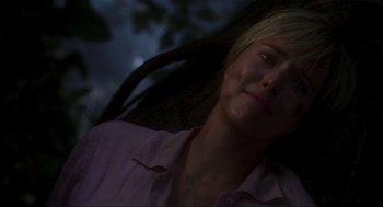 Movie still from “Jurassic Park III” (2001), directed by Joe Johnston – A woman sitting in a chair with her eyes closed; Close Up shot, Low angle