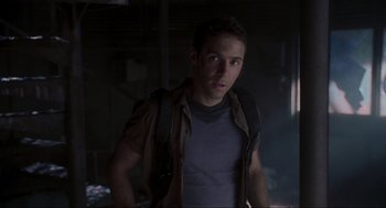 Movie still from “Jurassic Park III” (2001), directed by Joe Johnston – A man with a backpack standing in a dark room; Close Up shot, Low angle