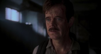 Movie still from “Jurassic Park III” (2001), directed by Joe Johnston – A person with a beard and a mustache; Close Up shot, Over the shoulder angle