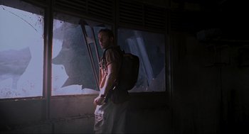 Movie still from “Jurassic Park III” (2001), directed by Joe Johnston – A man standing in front of an open window; Medium shot, Low angle
