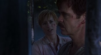 Movie still from “Jurassic Park III” (2001), directed by Joe Johnston – A man and a woman standing next to each other in front of a tree; Close Up shot, Over the shoulder angle