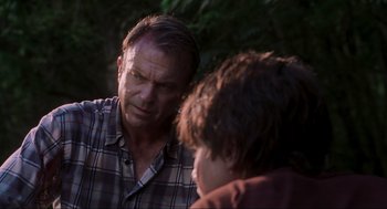 Movie still from “Jurassic Park III” (2001), directed by Joe Johnston – A man talking to a young boy in a plaid shirt; Close Up shot, Over the shoulder angle