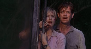 Movie still from “Jurassic Park III” (2001), directed by Joe Johnston – A man and a woman standing next to each other in front of a window; Medium shot, Low angle