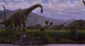 Movie still from “Jurassic Park III” (2001), directed by Joe Johnston – A group of people on a boat in a field with a bunch of dinasours in the background; Extreme Wide shot, Low angle