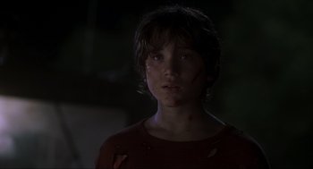 Movie still from “Jurassic Park III” (2001), directed by Joe Johnston – A young boy with a blood soaked face; Close Up shot, Low angle