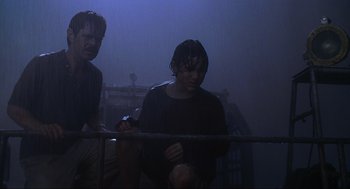 Movie still from “Jurassic Park III” (2001), directed by Joe Johnston – Two men standing next to each other on a foggy night; Medium shot, Low angle