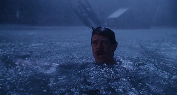 Movie still from “Jurassic Park III” (2001), directed by Joe Johnston – A man in the water in the middle of the night; Medium shot, High angle